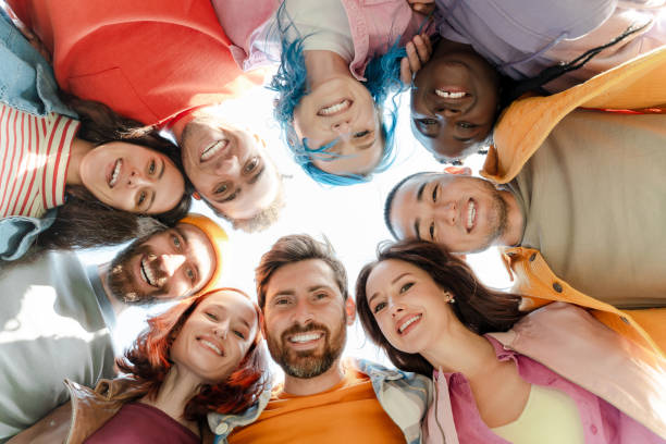 istock Diverse group of people forming circle smiling together 2180502056