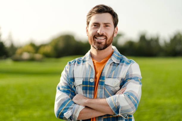 istock Smiling farmer standing with crossed arms in cultivated field 2180502152