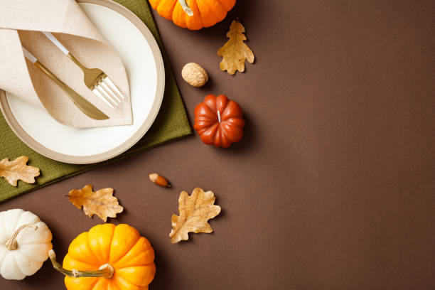 istock Autumn restaurant table setting with pumpkins and fall leaves, perfect for a warm and inviting dining experience 2180502217
