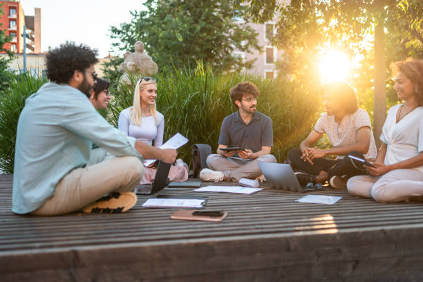 istock Diverse Executives Discuss Strategy Outdoors 2180503031