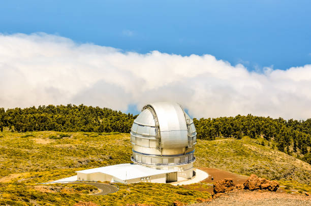 istock A large telescope is on a hill with a cloudy sky in the background 2180504885