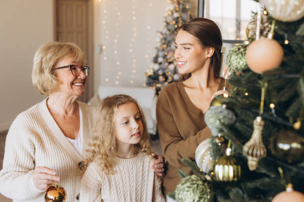 istock Three Generations Decorating Christmas Tree Together at Home 2180505439