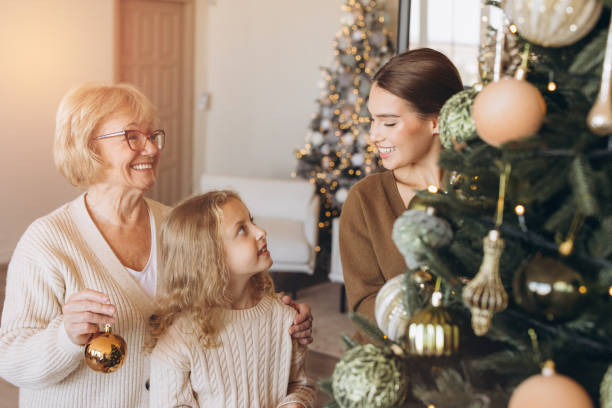 istock Three Generations Decorating Christmas Tree Together at Home 2180505479