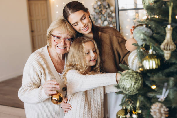 istock Family Decorating Christmas Tree Together With Joyful Smiles 2180505521