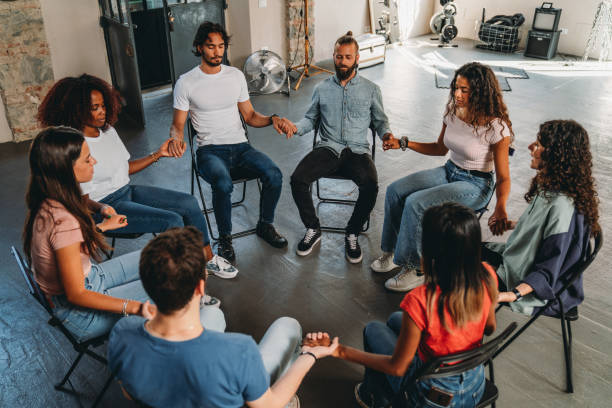 istock People are meditating together during a group therapy session 2180506975