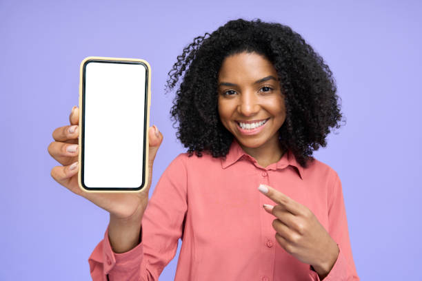 istock Happy young African girl showing big blank empty mock up mobile phone screen. 2180507771