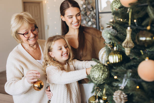 istock Family Decorating Christmas Tree Together With Joyful Smiles 2180509972