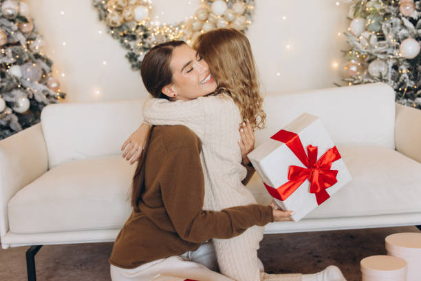 istock Joyful Christmas Gift Exchange Between Two Happy Friends 2180510140