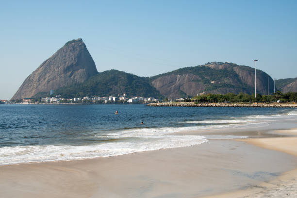 Salvador, Bahia, Brazil - February 02, 2023: Many people are on the rocks of Rio Vermelho beach offering gifts to Yemanja, in Salvador, Bahia.