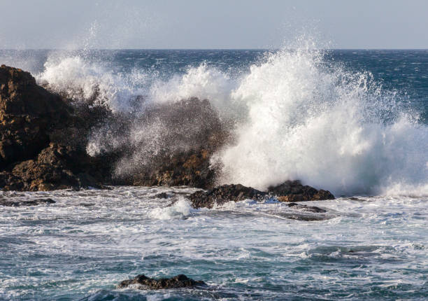 istock Ocean waves crushing against rocks 2180511848