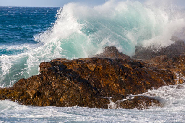 istock Ocean waves crushing against rocks 2180511863