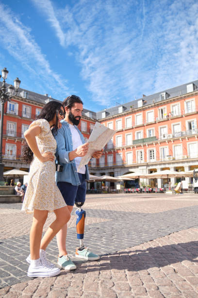 istock Young tourist couple with map visiting Plaza Mayor in Madrid 2180512449