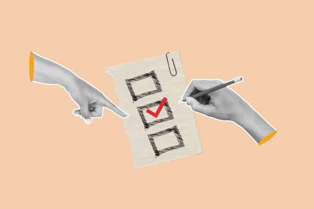 istock One hand pointing and one hand writing a red check sign on a beige background 2180518802
