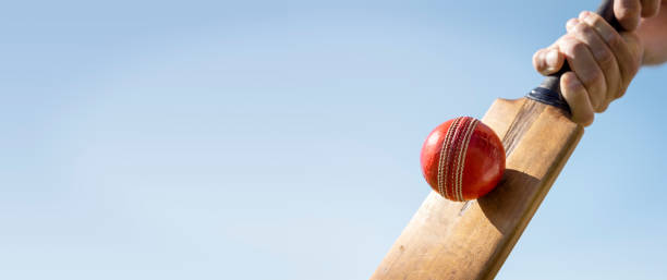 istock Cricket player batsman background hitting ball with a cricket bat shot from below 2180518967