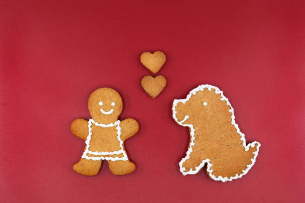 Smiling gingerbread woman, dog and hearts, copy space