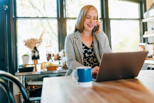 istock Women Hot Desking At Home On Kitchen Counter 2180531397