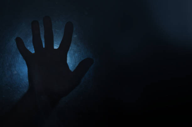 istock Frozen man with hand against a blue snowy background. 2180532327