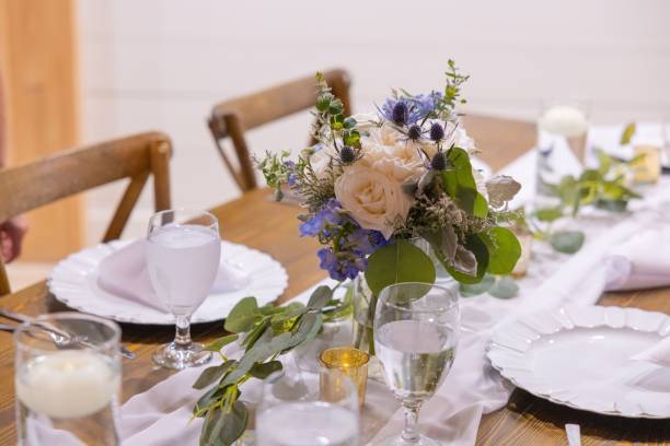 istock Elegant table setting with floral centerpiece. 2180533181