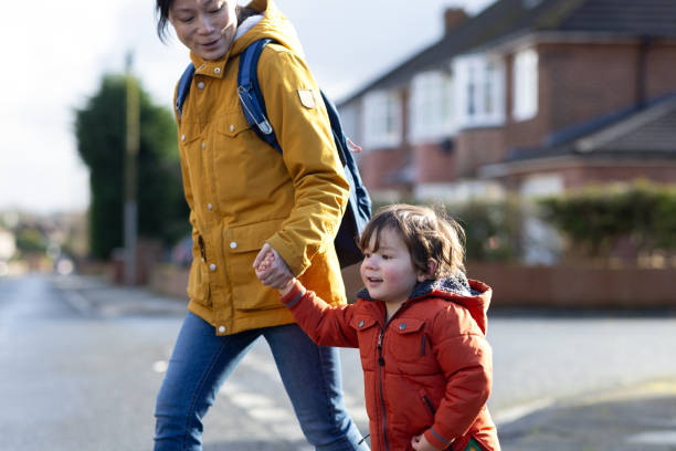 istock Mother and Son Walking Hand in Hand 2180533520