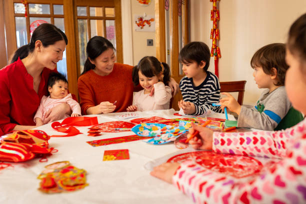 istock Adults Helping Children Make Chinese New Year Decorations 2180533917