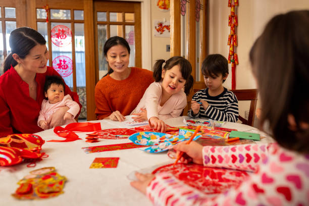 istock Family and Friends Making Traditional Decorations Together 2180533921