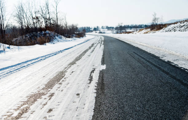 istock Country road covering with snow 2180535882