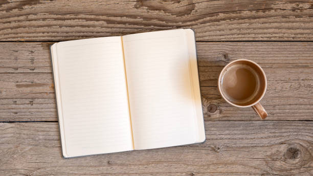 istock Notebook on a wooden background, spiral notepad and coffee on a table 2180538249