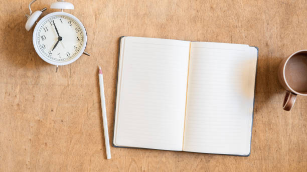 istock Notebook on a wooden background, spiral notepad and coffee on a table 2180538459