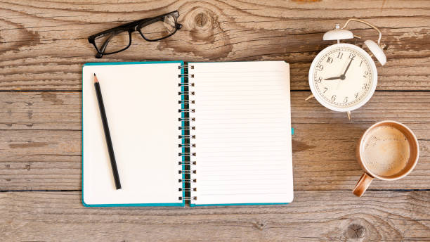 istock Notebook on a wooden background, spiral notepad and coffee on a table 2180538565