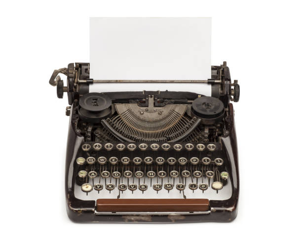Old vintage mechanical typewriter with a blank sheet of paper inserted. Isolated on the white background.