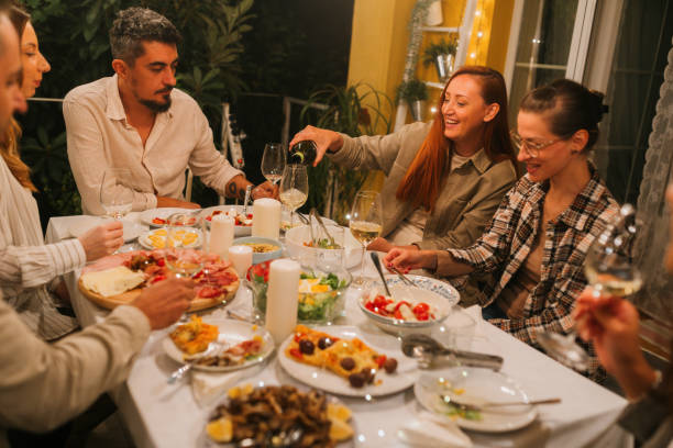 istock Young people dining outdoors 2180543361