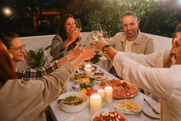 istock Friends having a toast while dining outdoors 2180543519