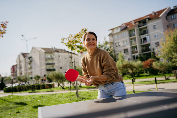 istock Playing pingpong in a public park 2180544727