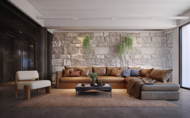 istock Leather sofa with stone wall in living room.3d rendering 2180545781