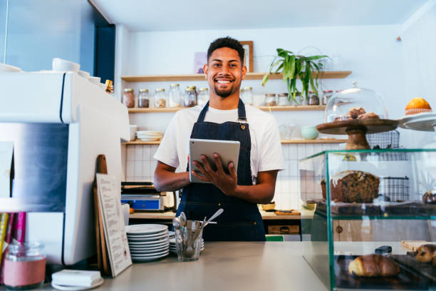 istock Barista working in a bar cafeteria 2180545886