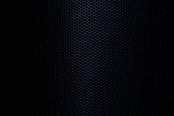 Close-up macro of black speaker surface,Protective decorative metal grill with honeycombs on modern acoustic systems. Music speakers close-up.