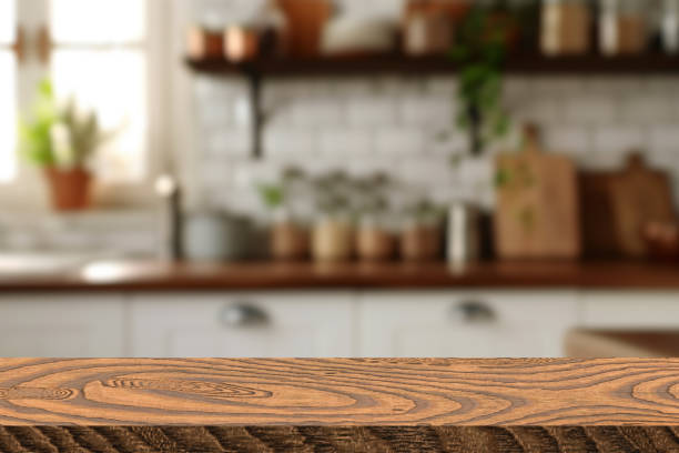 istock Empty wooden table and blurred kitchen background, product display 2180550113