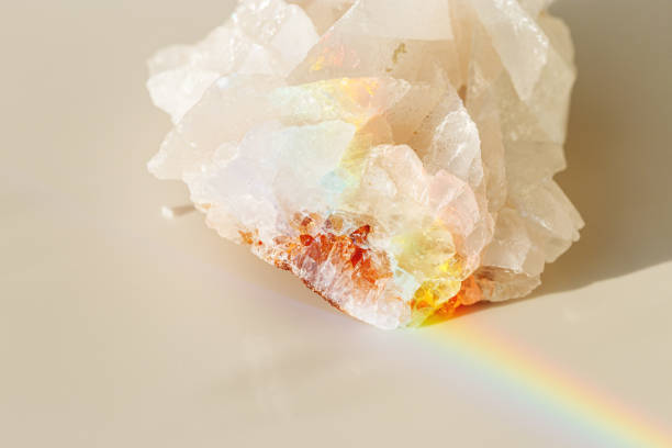 istock Luminous Quartz with Rainbow Flares. Sun's rays interact with quartz stone, iridescent rainbow glares, background with shining crystal at sunlight, aesthetic view with natural light effect 2180552060