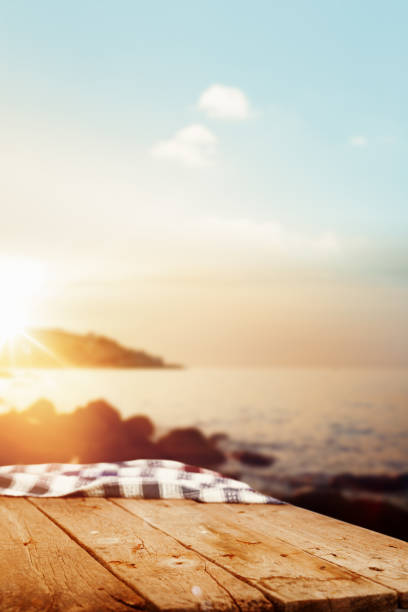 istock Empty wooden picnic table at sunset by the sea 2180552502