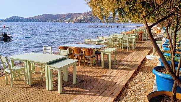 istock Empty tables and chairs restaurant by the sea 2180556029
