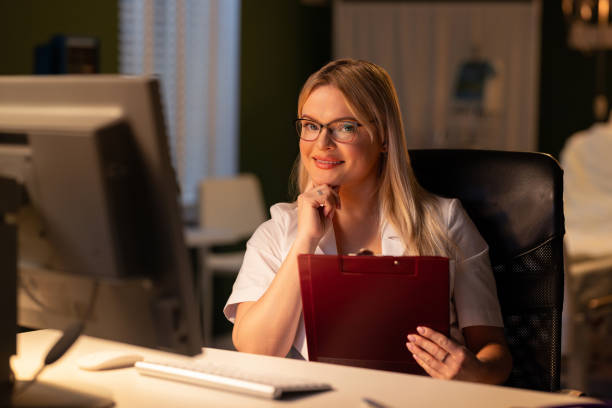 istock Seated with a folder, the doctor discusses the treatment plan with the patient using her computer online consultation 2180560090