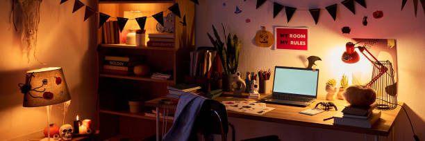 istock Table with laptop and Halloween symbols 2180561264