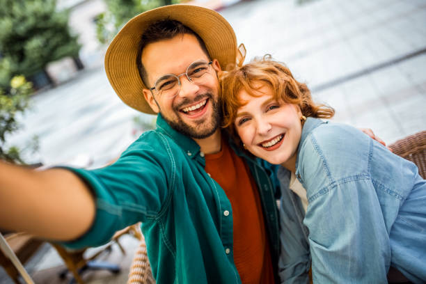 istock Young couple on a vacation taking selfies in the restaurant. 2180566648