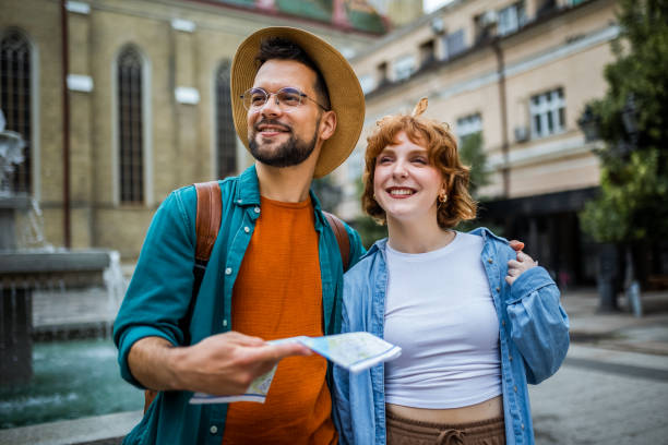 istock Young couple using a map to explore the new city on their vacation. 2180566787