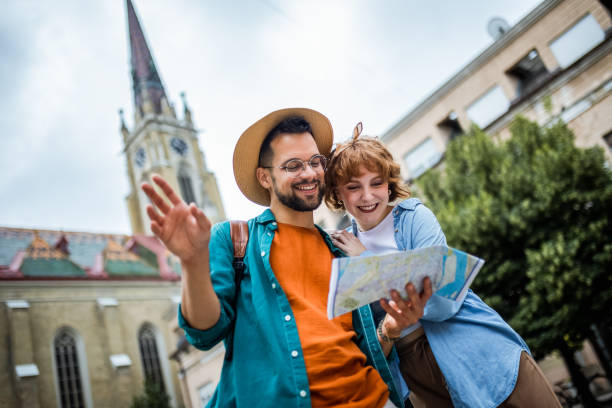 istock Young couple using a map to explore the new city on their vacation. 2180566827