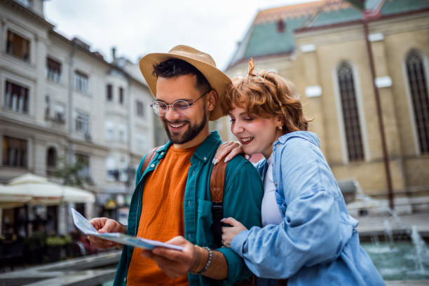 istock Young couple using a map to explore the new city on their vacation. 2180566855