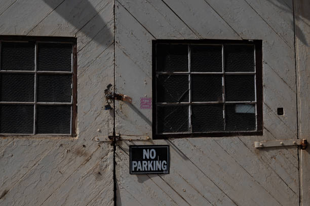 istock No parking sign posted on old building 2180569279