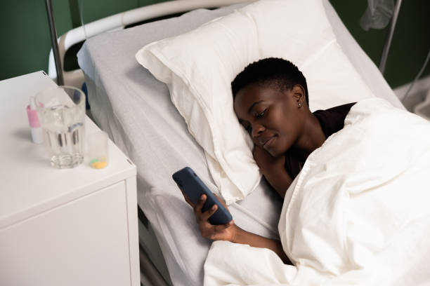 istock Young African woman looks at her phone, really focused 2180573628
