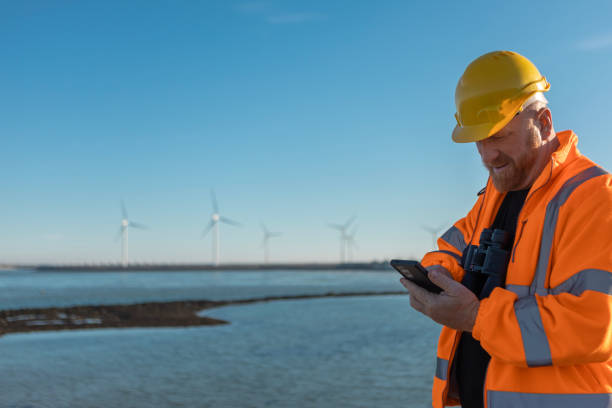 istock An engineer during his daily duties at a waterside windmill turbine power site 2180574383