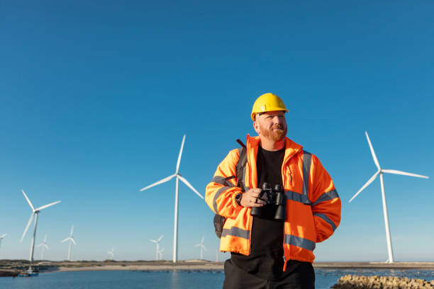 istock An engineer during his daily duties at a waterside windmill turbine power site 2180574385